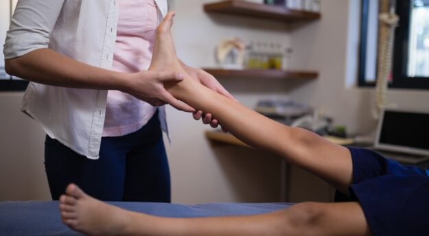 Medical Podiatry Podiatrist examining foot