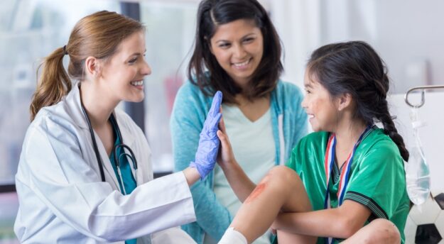 Doctor high-fiving young girl