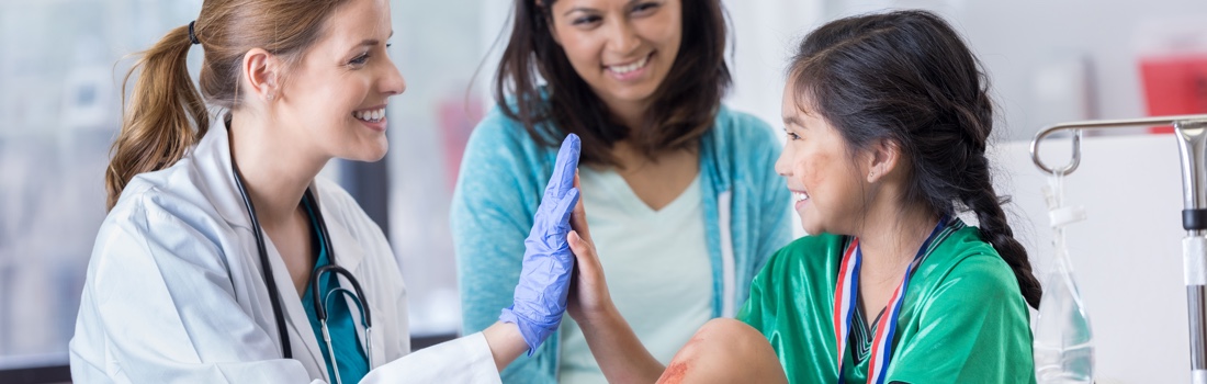 Doctor high-fiving young girl