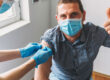 Man with thumb up getting vaccine